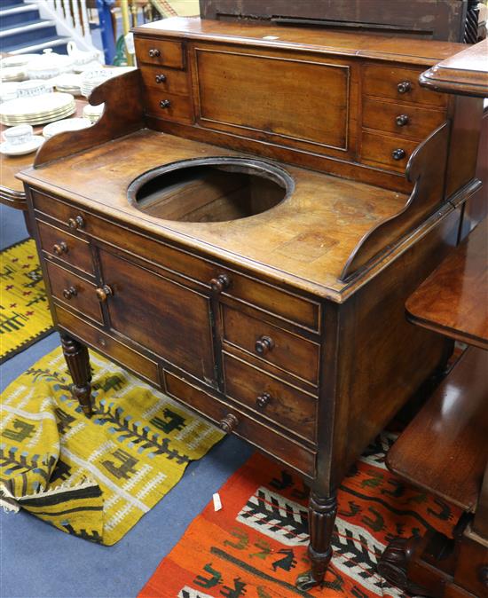 A Regency mahogany washstand with cistern compartment and basin recess W.94cm.